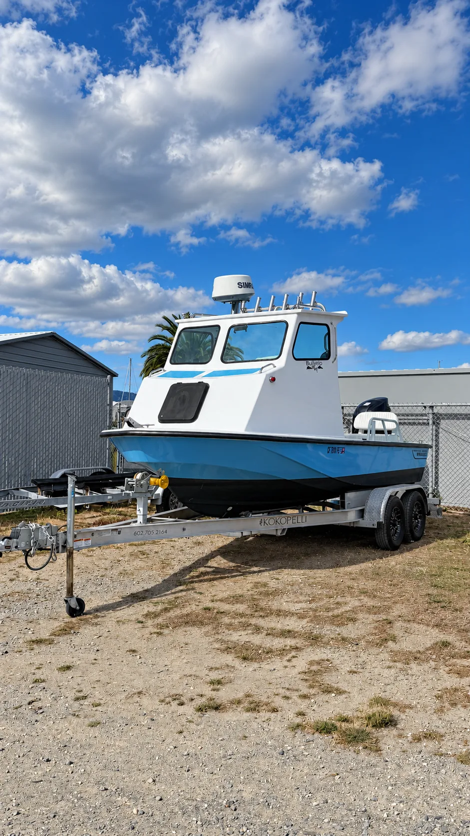 Cabin boat stored on its trailer in dry boat storage at Marinship Industries Storage, Sausalito